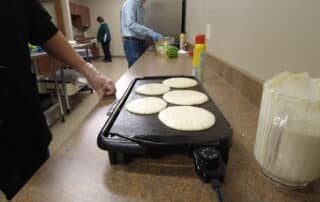 Team Leaders making pancakes and french toast for Team Members during DuraTech's annual Pancake Breakfast.
